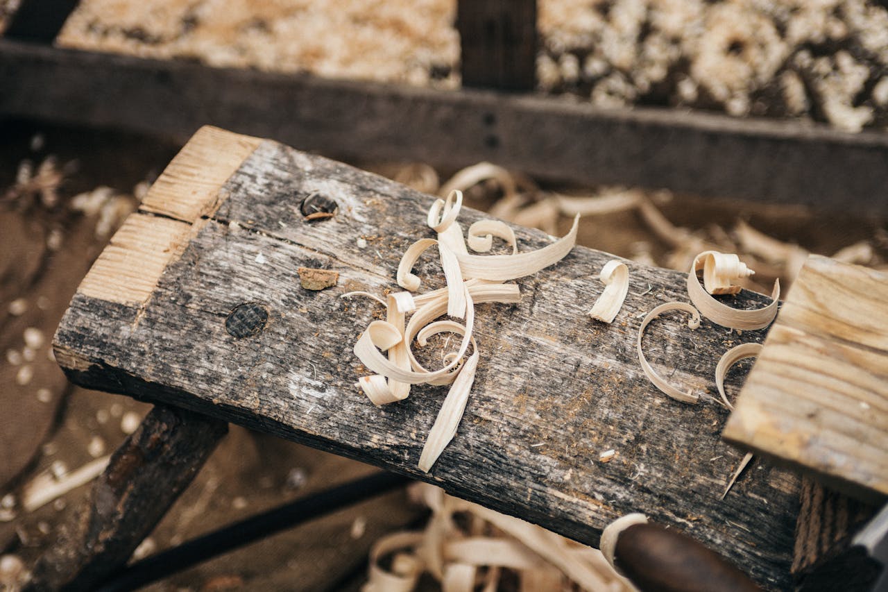team-01 Rustic workbench covered in wood shavings, showcasing detailed craftsmanship.