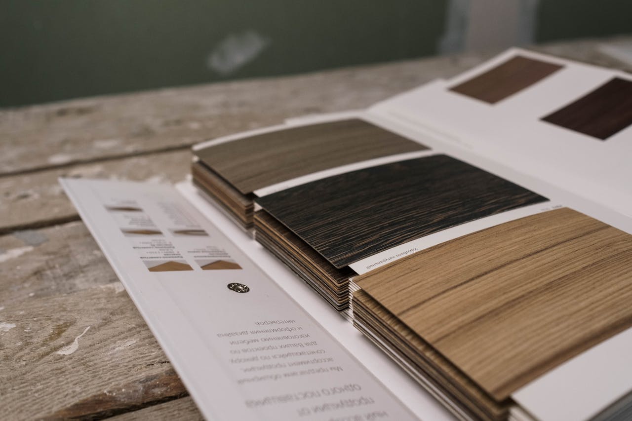 who-we-are Collection of wood veneer samples displayed on a rustic wooden table indoors.